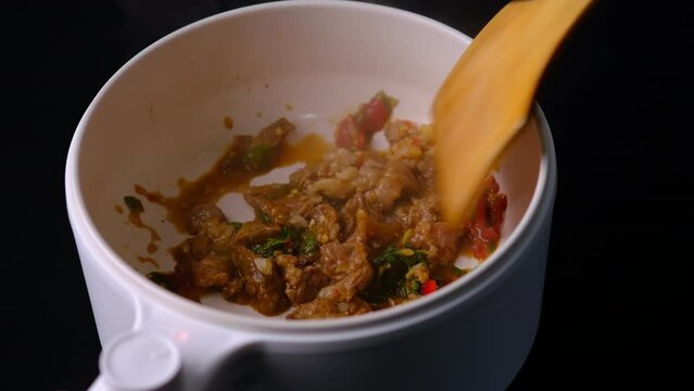 stir-fried beef with holy basil and chili in electric pot