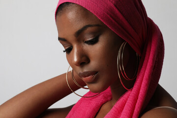 Beautiful African American woman with traditional turban on white wall. Mock-up.