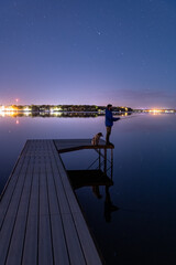 Fishing With Dog On Dock Reflection