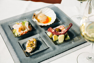 Venetian Cicchetti with shrimps, scallop, octopus and potatoes, and sea bass 