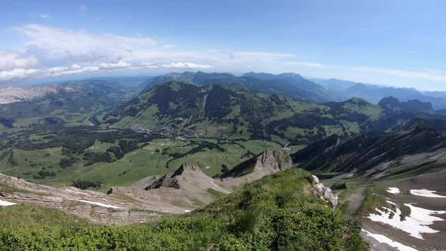 Panning view of the valley in the swiss alps in Switzerland from the Brienzer Rothorn near Brienz with a clear blue sky and Faulhorn in sight