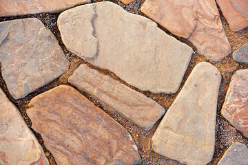 The road is made of masonry of large sizes and different colors