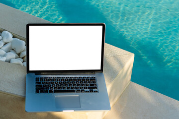 laptop with blank screen near the pool