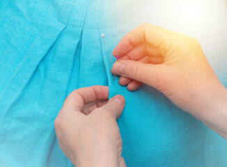 The use of tailor pins on the mannequin. The process of making handmade clothes.
