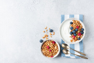 Healthy breakfast Greek yogurt bowl with granola and berries. Top view copy space for text or...