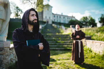 Fototapeta na wymiar Two monks outside the monastery pray.