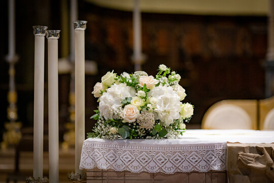 Decoration composed of white roses and hydrangeas on the altar of a christian church. Wonderful decoration for a wedding.