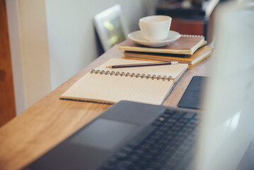 Desk for student education concept. Book, laptop, coffee, and pencil on School table for student working online at home.