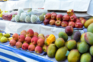 mangoes, apples and other fruits in the street market 