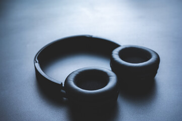 Solo wireless black bluetooth headphones lying alone on black background