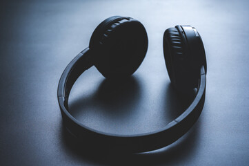 Solo wireless black bluetooth headphones lying alone on black background