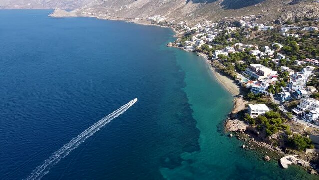 Static aerial shot of a speed boat coming to Massouri village on sunny day. Kalymnos island, Greece.