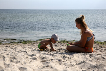 little boy with mother on the sea beach