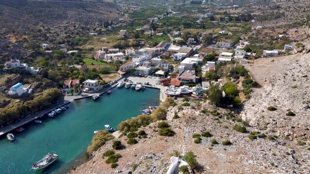 Crane aerial shot of Vathys village, its marina and Saint Irene church. Kalymnos island, Greece.