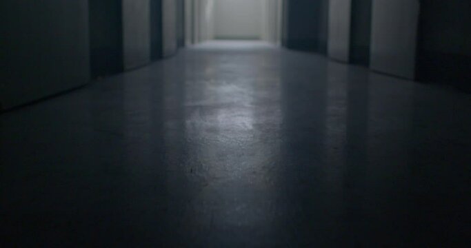 The movement of the floor in the dark corridor of the prison. A glare of light in the menacing floor, the surface. There is light at the end of the corridor. Low mental state.