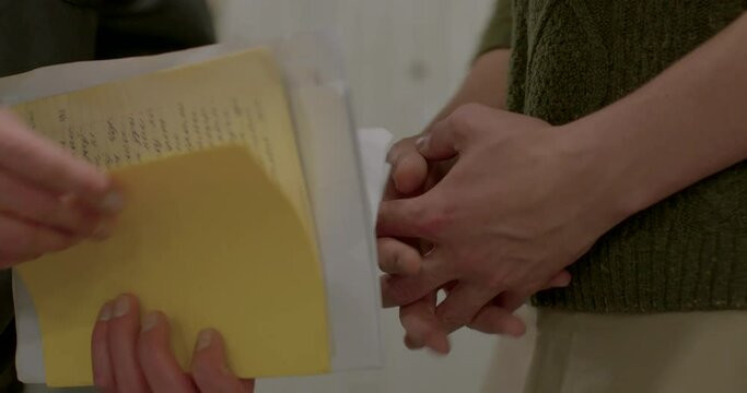 Close-up of the hands of male spies, control of documents during transmission. The hand opens a paper folder, takes it in his pocket.
