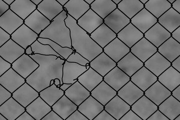 chain-link mesh, in the photo is a torn metal mesh on a gray background