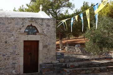 Fototapeta na wymiar crete old church with flags