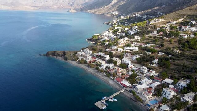 Aerial forward reveal footage of Mirties and Massouri villages on Kalymnos island on sunny day. Aegean Sea, Greece.