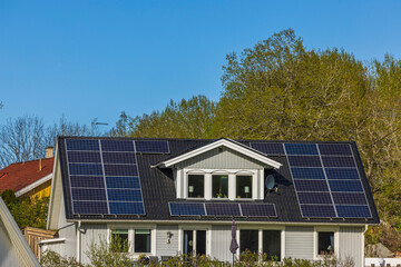 Beautiful view of house roof equipped with solar panels. Sweden. 