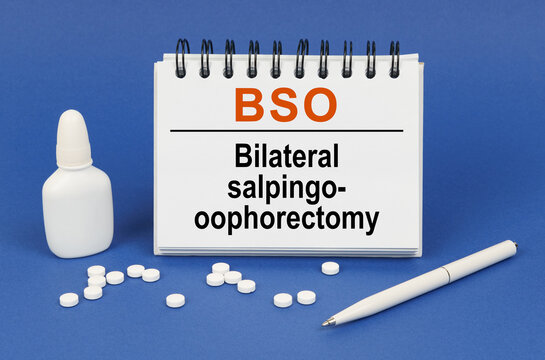 On a blue background, a pen, tablets and a notepad with the inscription - BSO Bilateral salpingo-oophorectomy