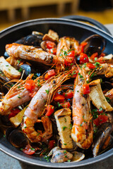 Venetian restaurant cooking scampi or Norway lobster