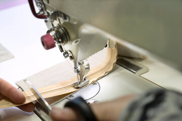 Sewing on industrial sewing machine. Stitching a zipper on a sewing machine. Sewing process.