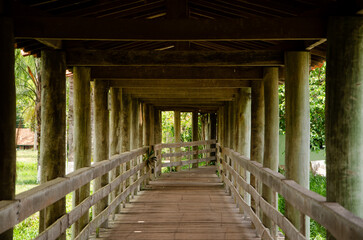 Wooden structure, with bridge, that passes over a lake. 