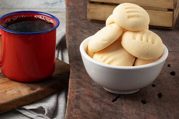 Brazilian cream cookie (biscoito de nata) served with coffee. Selective focus.