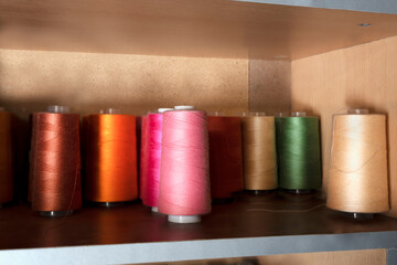 Close-up of multicolored spools of thread for the industrial sewing machine.