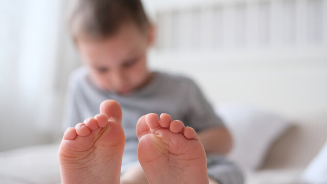 Close-up of childrens legs with feet forward