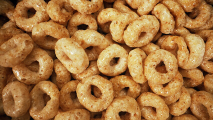 Macro view of cereal circles in bowl.