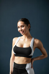 Fototapeta na wymiar Portrait of a beautiful smiling fitness woman in black and white sportswear