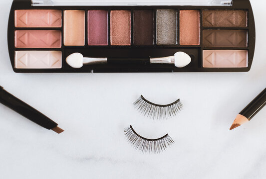 Overhead Flat Lay Of Eye Makup With Shadow Palette, Eyeliner And False Eyelashes