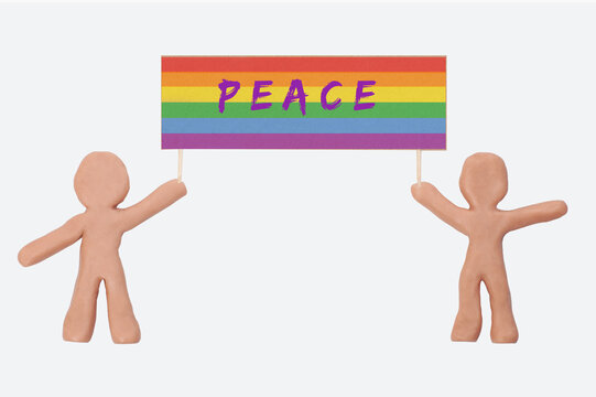 two clay figures holding a rainbow flag