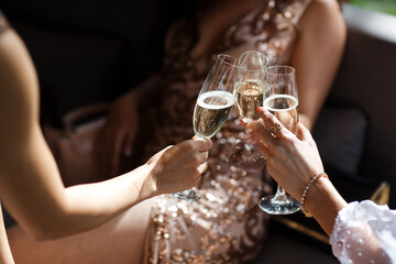 Bride and bridesmaids clink glasses at a wedding
