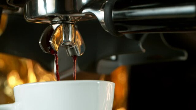 Close-up Slow Motion of Espresso Pouring from Coffee Machine.
