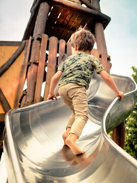 child climbing wooden slide montessori
