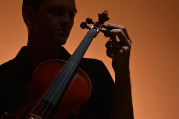 Violin being tuned by musician