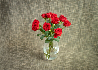 Red roses and woven fabric background