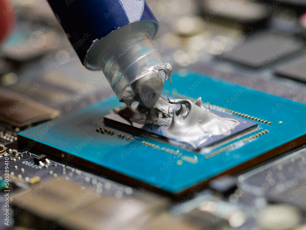 Poster technician applying thermal paste to a gpu on laptop motherboard. thermal paste on the processor. cl
