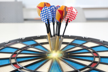 Dart arrow lands in the target center of the dartboard, completing the company success aim.