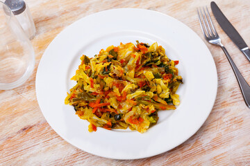 Stewed cabbage served on table. Portion of braised vegetables.