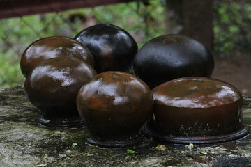 Traditional wet handmade pots in the rainy day after rain.