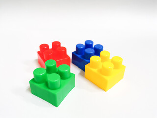 Colorful plastic building blocks against white background. Education and development concept.