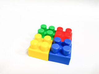 Colorful plastic building blocks against white background. Education and development concept.