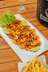 Colorful Food Beach Appetizer Starts Snacks Fresh Delicious Menu Recipe Meal Meat Chicken Fries Fish Seafood Beer on a wooden table