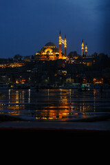 Fototapeta na wymiar Suleymaniye Mosque with lights in the evening in the Istanbul skyline. Turkish city at night.