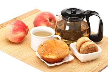 cake,cup and teapot of tea on white background