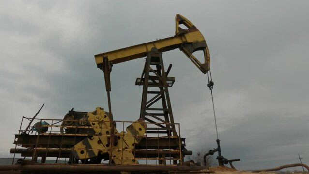 Pump jack for crude oil. Oil rocking chair. Oilfield. Up and down.